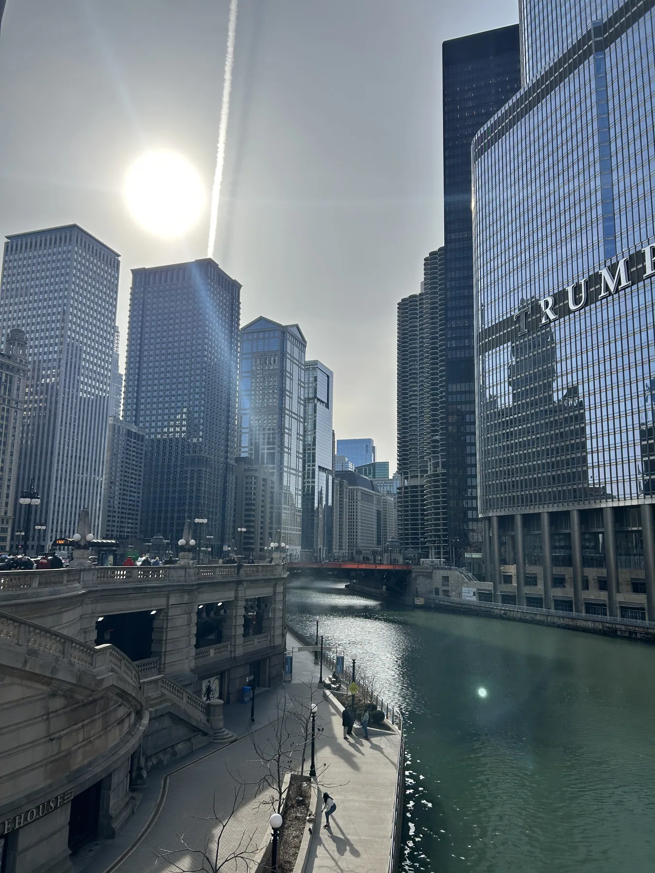The Chicago River surrounded by downtown buildings in daylight.