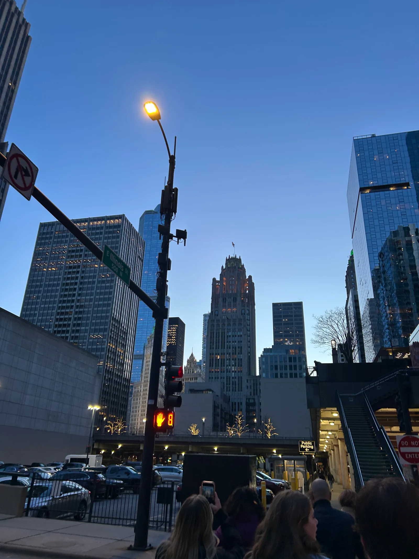 A downtown Chicago street crossing framed by tall buildings.
