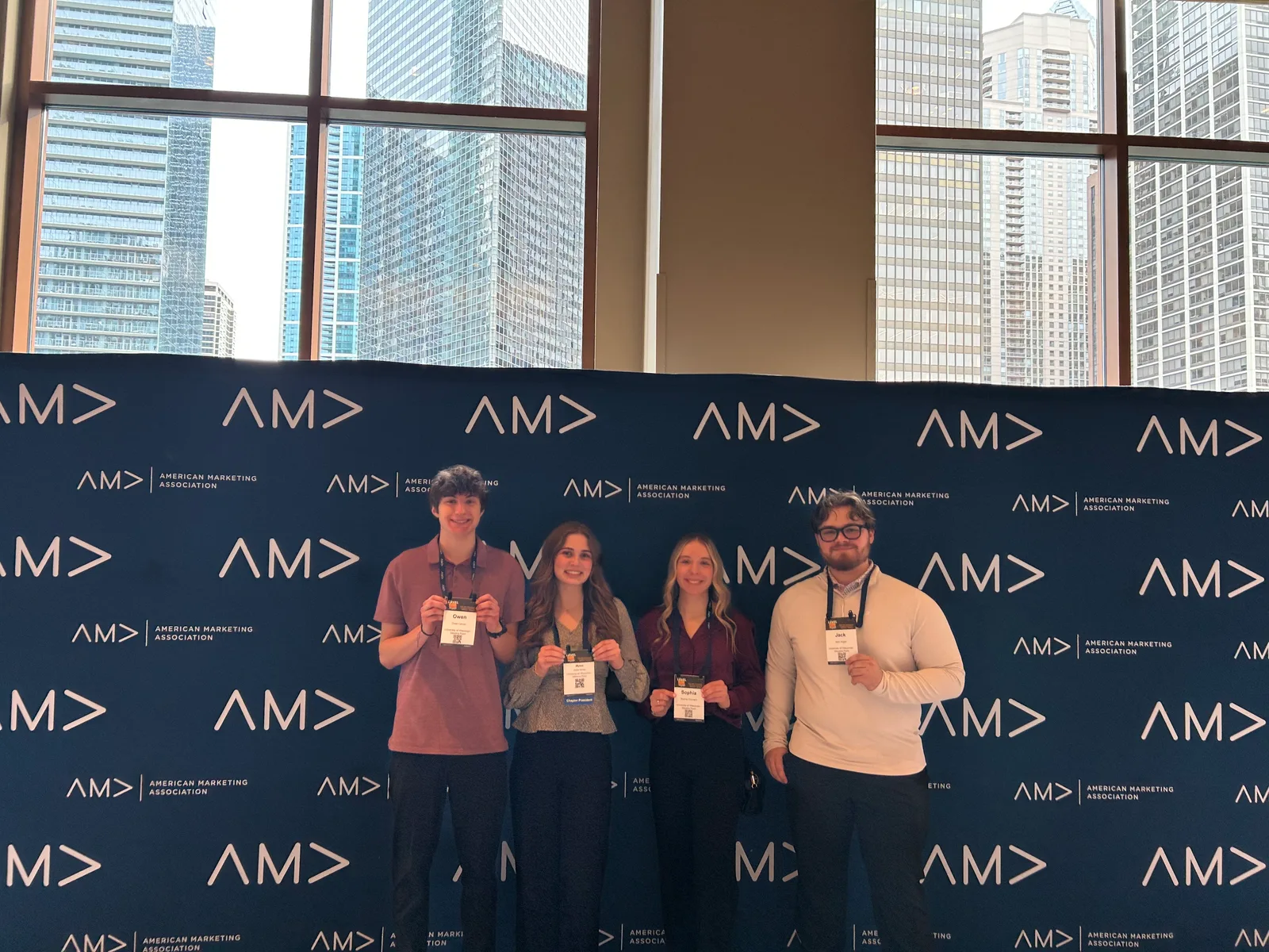 Conference attendees inside a room with an American Marketing Association backdrop.