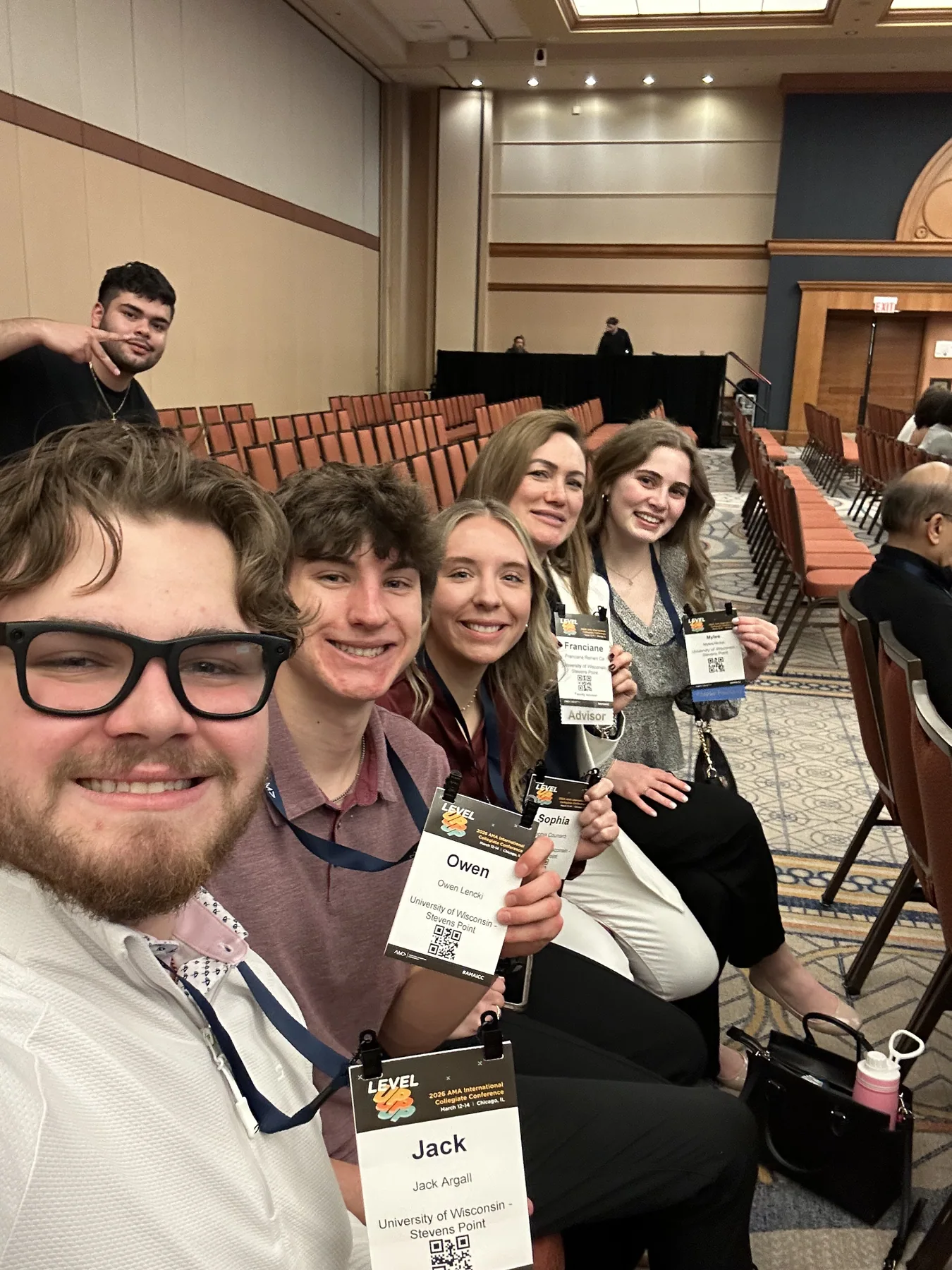A UWSP AMA group taking a candid photo together in a conference session room.