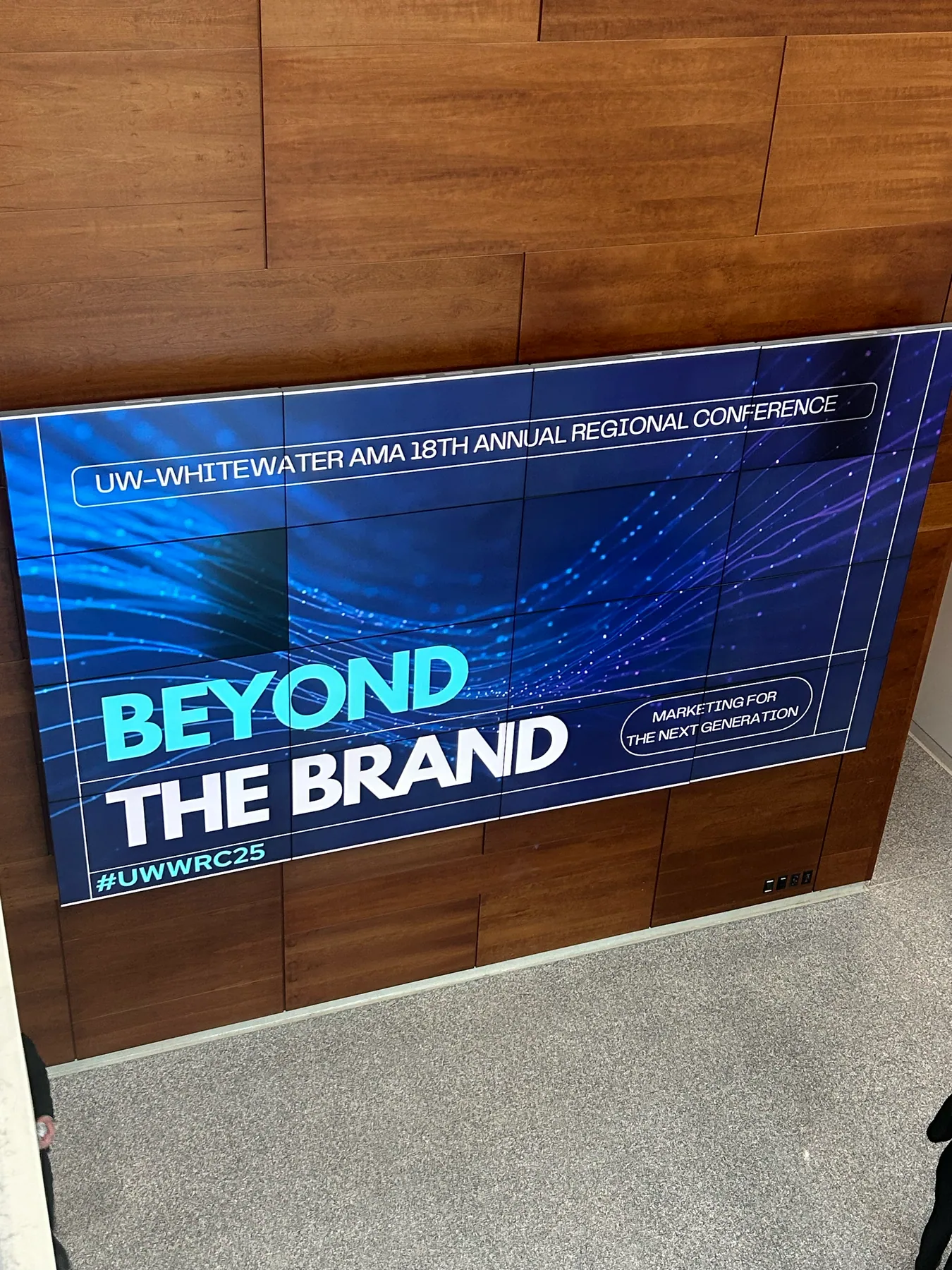 A lobby video wall showing the conference theme, Beyond the Brand, Marketing for the Next Generation.